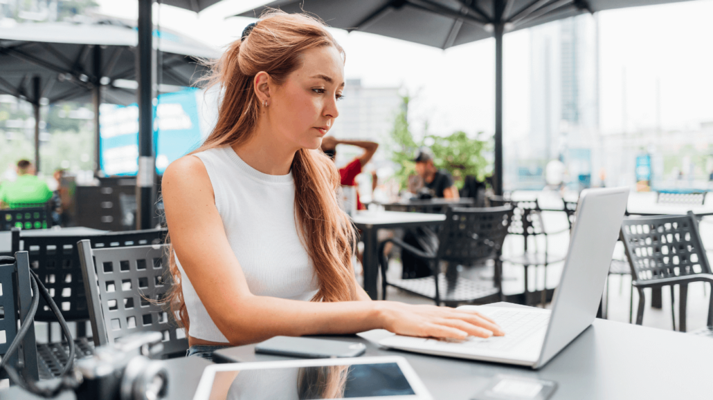 A woman looking down at her laptop.