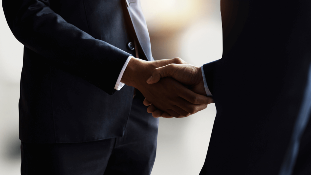 A handshake between two people in suits