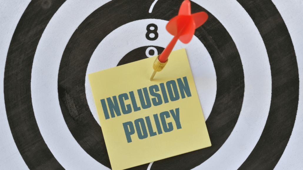 a target with a sticky note containing "inclusive policy" pinned to the center