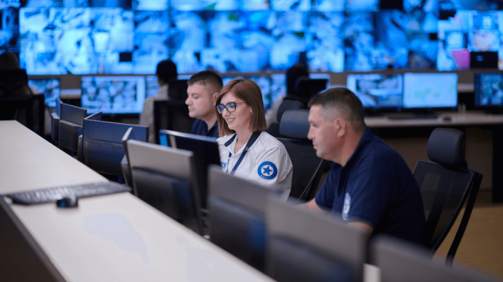 Security staff looking at monitors